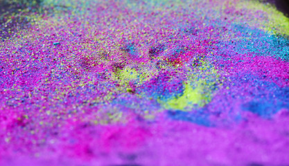 Abstract multicolored powder splatted on black background. Colorful dust explode. Painted Holi...