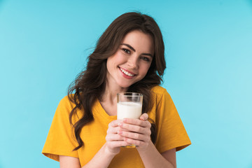 Positive optimistic young beautiful woman holding milk.