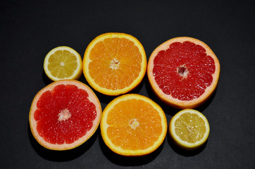 fruit citruses red grapefruit orange yellow lemon on a black background top view horizontal orientation