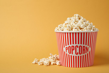 Delicious popcorn on yellow background. Space for text