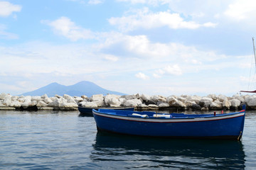 Fototapeta na wymiar Wooden small old boat in porto Napoli Margelina seafront, italian travel destination.