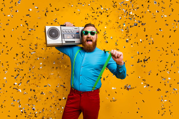 Portrait of energetic crazy man want retro disco party hold vintage boom box pull green suspenders...