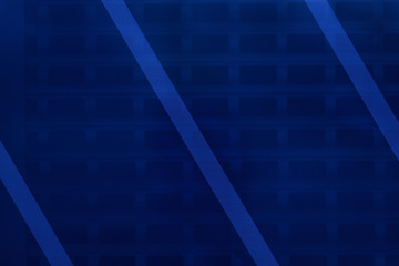 Vivid blue geometric background with diagonal lines. Bright blue fabric with metal lattice underneath. Modern building door close up. Copy space