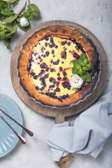 clafoutis - traditional french berries pie, dessert on rustic wooden table.