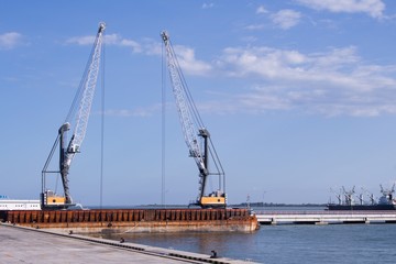 Fototapeta premium 2 units of Harbor Mobile Crane (HMC) are being loaded onto barges