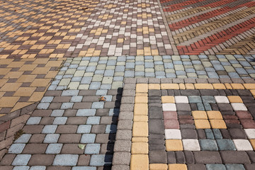 Fototapeta premium Streetlights and texture of different colored patterned paving slabs on the ground of street