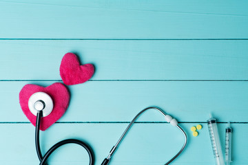 World heart health day concept and Healthcare medical insurance with red heart and stethoscope on blue wooden background