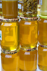 Pile of glass honey jars on the farmers market . Homemade honey.