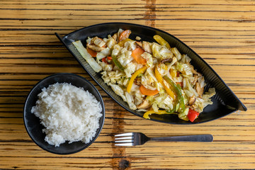 Healthy snack of assorted farm fresh roast vegetables and mushroms in a plate on a rustic table, close up