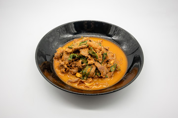 Thai red chili curry stir fried with beef shank, basil, and black pepper. One of most popular home cooking spicy menu isolated on white