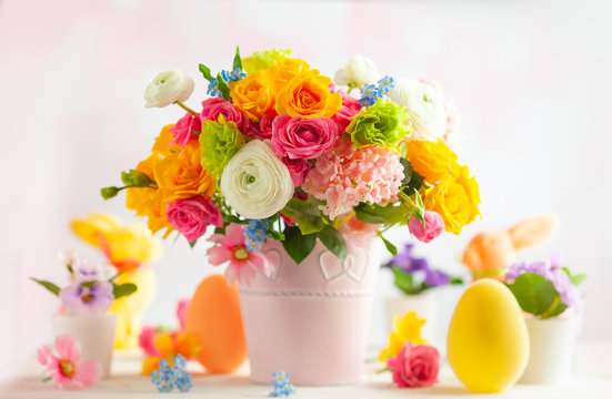 Easter Decoration With Beautiful Spring Flowers In Vase, Easter Eggs And Bunny On White Wooden Table. Easter Concept