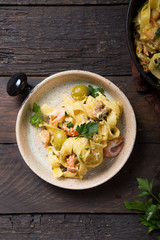 Seafood fettuccine pasta with crayfishes, octopus shrimps, on stone pan. Gourmet dish