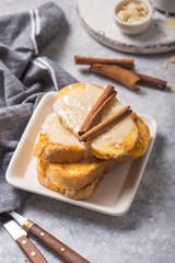 Traditional homemade Spanish torrijas on wooden background. Easter dessert.