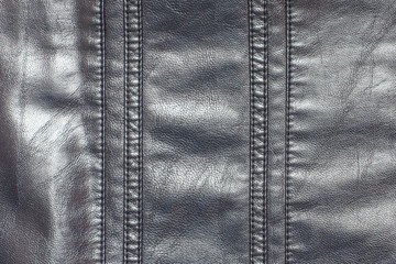 A fragment of leather fabric with stitched inserts