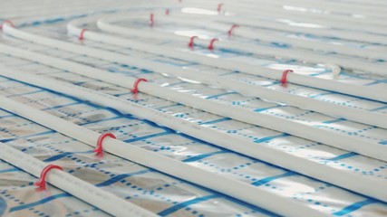 Slider shot of Pipes for hot water in a water heating system. Warm floor