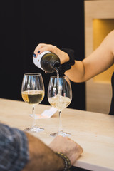 Girl serving a glass of white wine