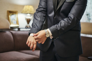 Businessman wears a jacket,male hands closeup,groom getting ready in the morning before wedding...