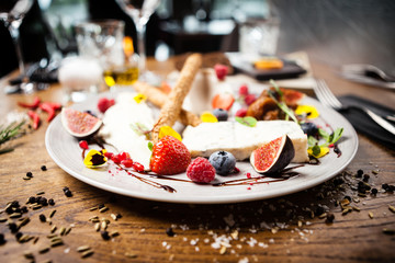 Cheese platter for two served on a plate in restaurant