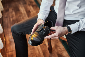 Fototapeta premium businessman clothes shoes, man getting ready for work,groom morning before wedding ceremony. Men Fashion