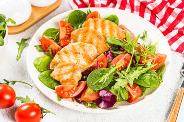 Salad with Grilled chicken, green leaves and vegetables.