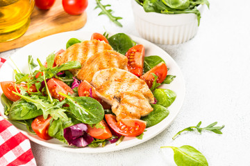 Salad with Grilled chicken, green leaves and vegetables.