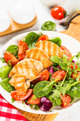 Salad with Grilled chicken, green leaves and vegetables.