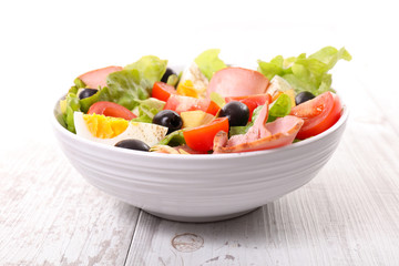 mixed vegetable salad with tomato, ham, egg, olive and lettuce