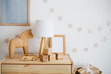 Stylish scandinavian newborn baby room with wooden toys and lamp. zero waste. eco-friendly materials