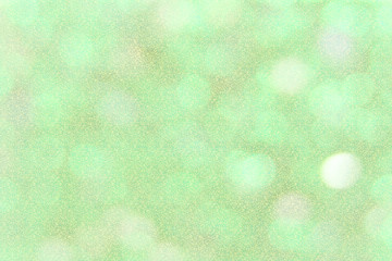 green and gold bokeh background with glitter.