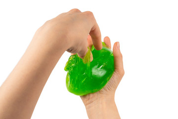 Green slime toy in woman hand isolated on white.