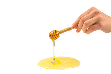 Dipper with honey in woman hand.