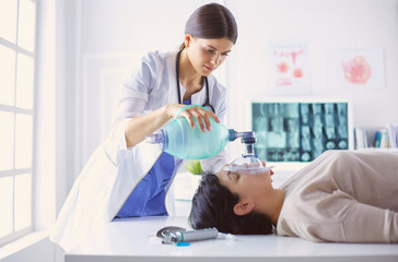 Doctor putting an oxygen mask in the hospital