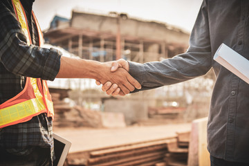 Engineer two people shake hand agreement project estate building construction