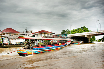 Tourists experienced with canal or Klong  tour by long tail boat and riding bicycles in Bangkok Noi, Thonburi, Thailand.