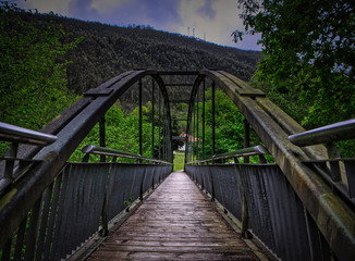 Fototapeta na wymiar Iron bridge over the train tracks in Cantabria. Spain.