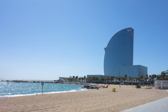 BARCELONA, SPAIN. May 15-2019:  Barceloneta Promenade and San Sebastian beach with W Hotel in the background. Barcelona, Spain.