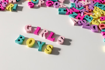 Girls and Boys made of colorful wooden Letters isolated on a White Background