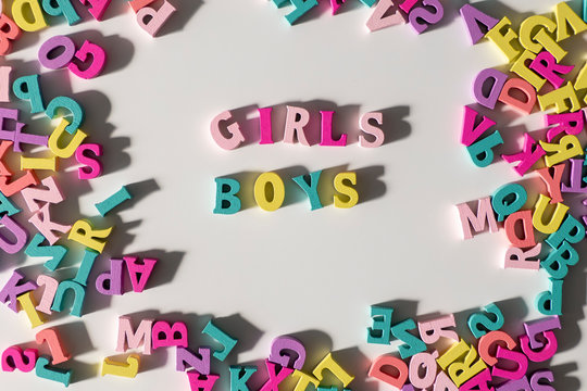 Girls and Boys made of colorful wooden Letters isolated on a White Background