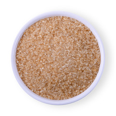 Bowl of brown sugar isolated on white background, top view.