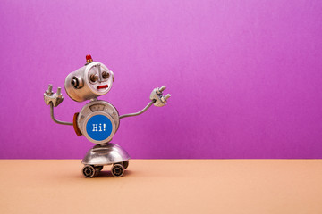 Four-wheeled metallic chat bot robot on purple brown background. Silver color domestic robotic...