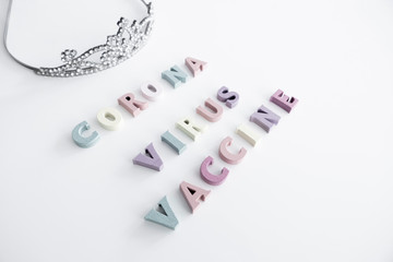 Coronavirus Colorful Game Letters on a White Background and a Crown