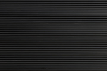 black steel shutter door. grunge black metal foldable door background and texture.