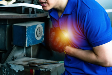 Heart attack with young man clutching his chest..engineer  accident working in industrial factory