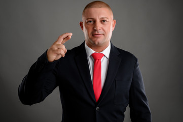 Businessman dressed in suit showing good luck