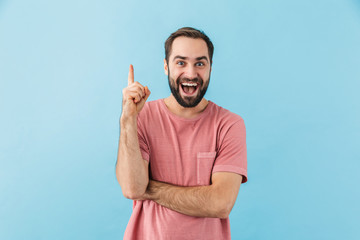 Fototapeta premium Pleased man posing isolated over blue wall background.