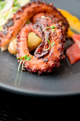 Octopus. Fresh caught octopus, seasoned with salt & pepper & grilled w/ olive oil and lemon juice. Served w/ a green leaf salad, heirloom tomatoes, red onions and Kalamata olives.