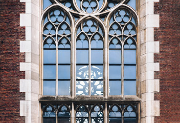 Pointed gothic windows with stained glass on facade of the building. Baroque and Gothic architecture. Church of St. Olga and Elizabeth. Lviv, Ukraine.