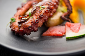 Octopus. Fresh caught octopus, seasoned with salt & pepper & grilled w/ olive oil and lemon juice. Served w/ a green leaf salad, heirloom tomatoes, red onions and Kalamata olives.