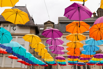 Colorful umbrellas hanging over the square du Martray, Pontivy, Brittany, France