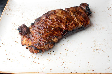 Steak. Grade A, grass fed angus beef. Traditional classic New York steakhouse menu favorite. T-bone steak, bone in, cooked to medium to rare and sliced. 